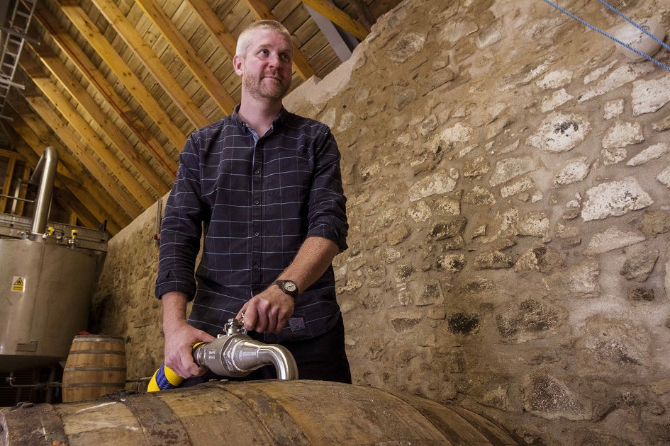 Gordon filling barrels with ecological whisky
